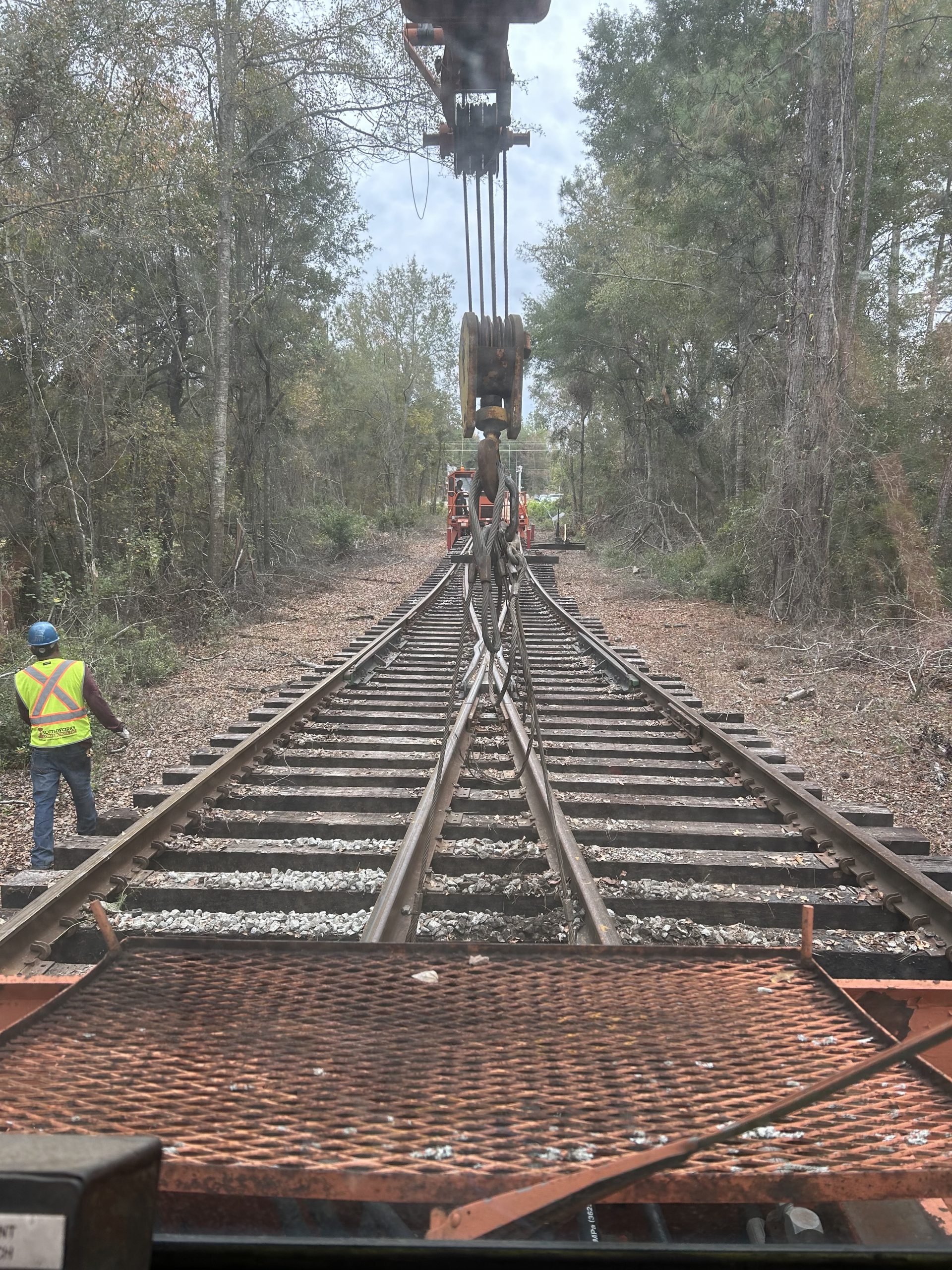 A machine placing down a diverging railroad track.